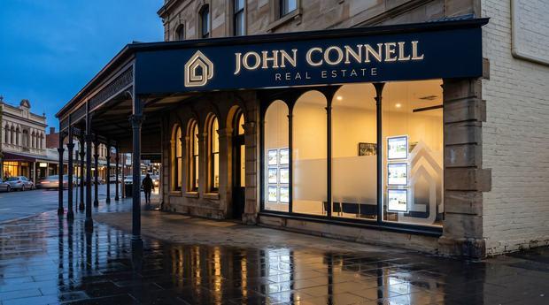 Illuminated shopfront fascia signage for John Connell Real Estate