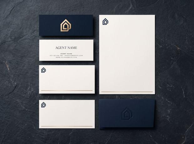 Branded stationery set — business cards, letterhead and with-compliments slips in navy and gold